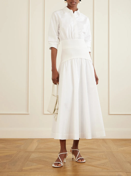 Image of a model wearing Skirts. Product name - Ovie Pleated Ribbed Cotton-poplin Midi Skirt in White colour by brand - SIMKHAI