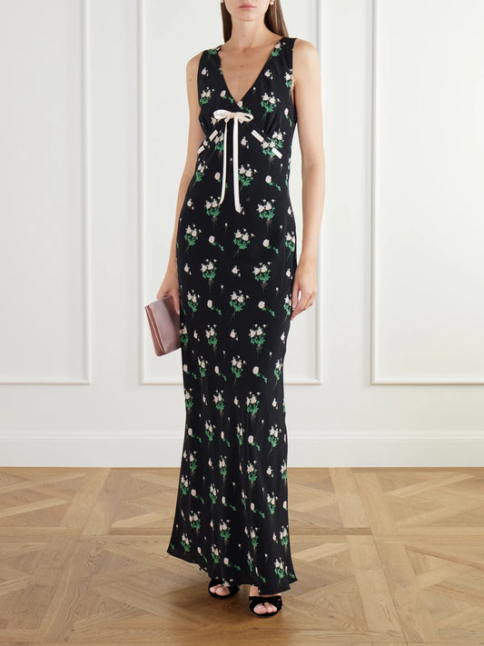 Image of Dresses. Product name - Camille Bow-detailed Floral-print Silk Crepe De Chine Gown in Black colour by brand - BERNADETTE