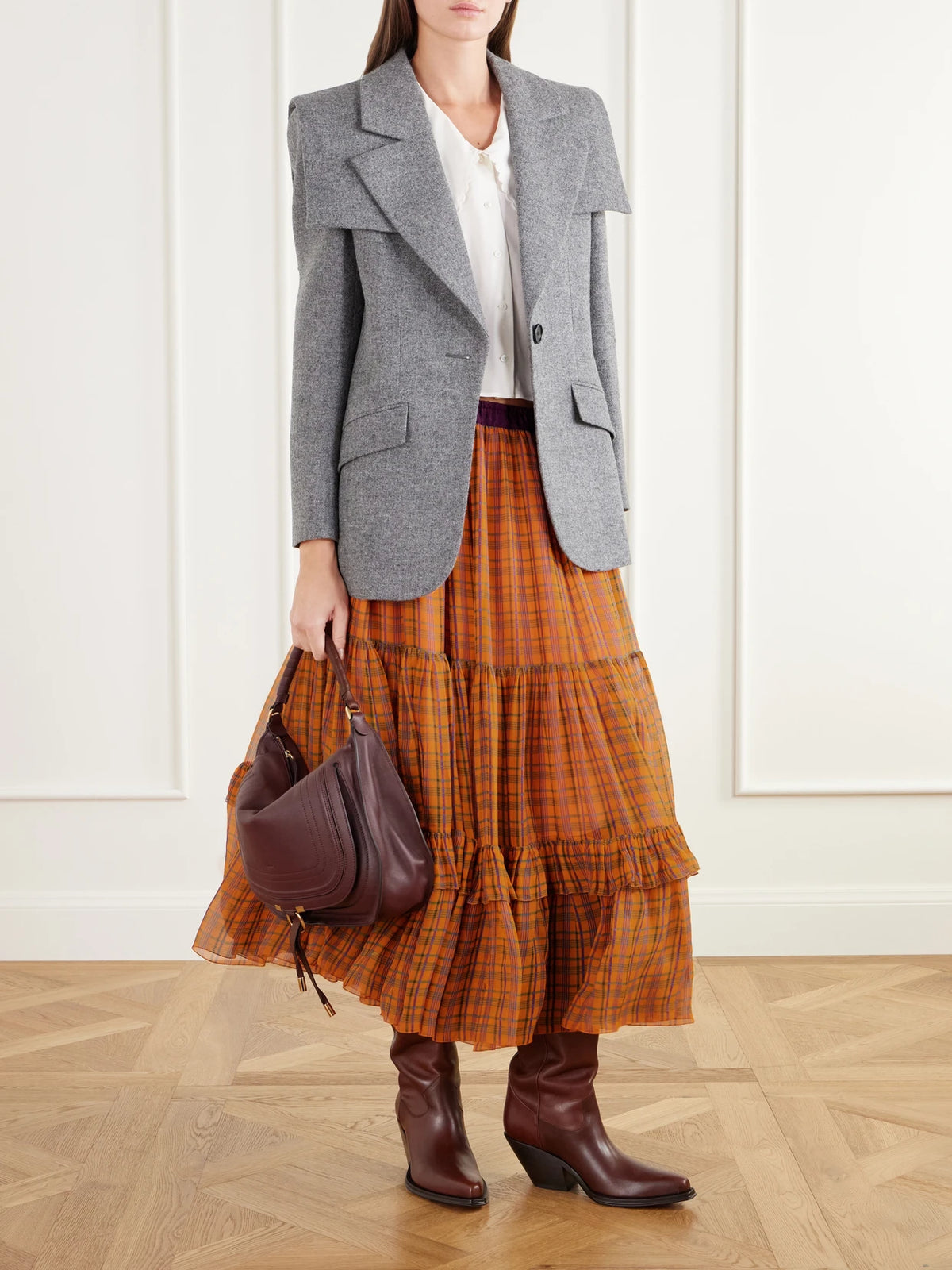Image of a model wearing Skirts. Product name - Ruffled Tiered Checked Silk-mousseline Midi Skirt in Orange, Pink colour by brand - Chloé