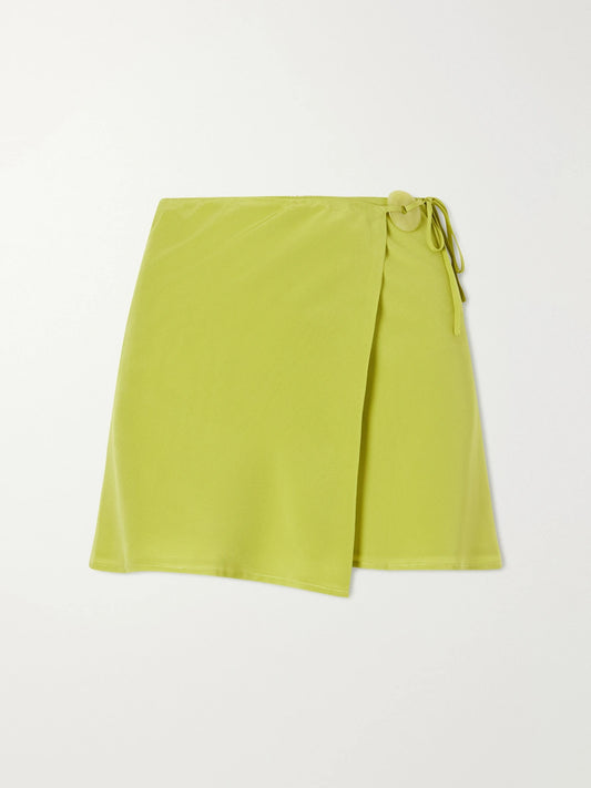 Image of a model wearing Skirts. Product name - Jade-embellished Silk-crepe Wrap Mini Skirt in Lime green colour by brand - Sara Cristina