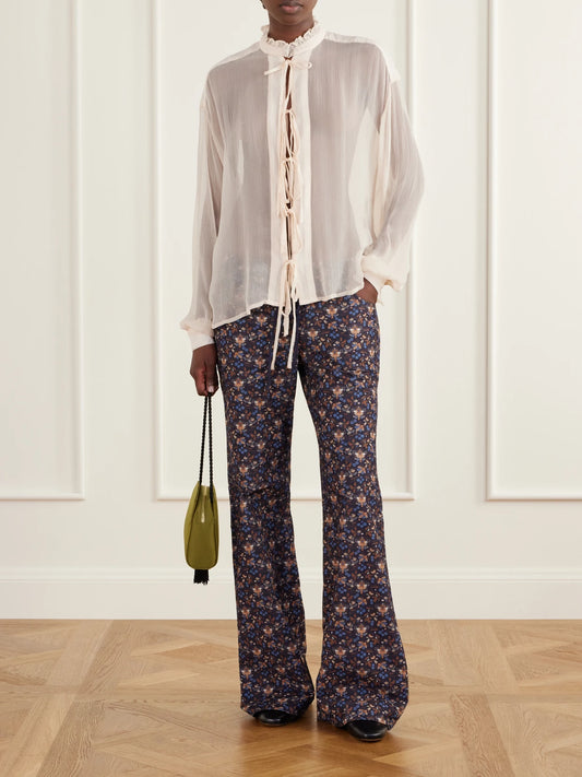 Image of a model wearing Tops. Product name - Willa Lace-up Gauze Blouse in Off-white colour by brand - ALIX OF BOHEMIA