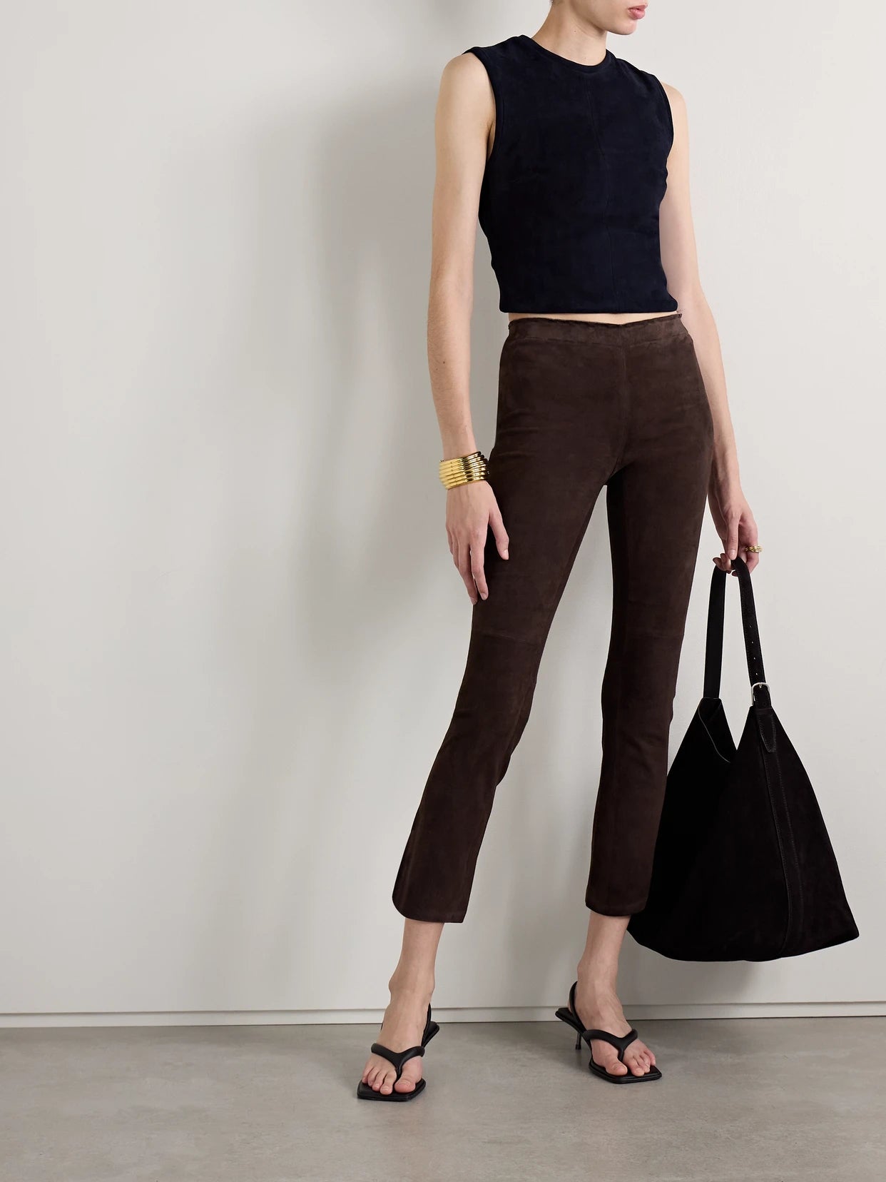 Image of a model wearing Pants. Product name - Jp Twenty Cropped Suede Flared Leggings in Dark brown colour by brand - STOULS