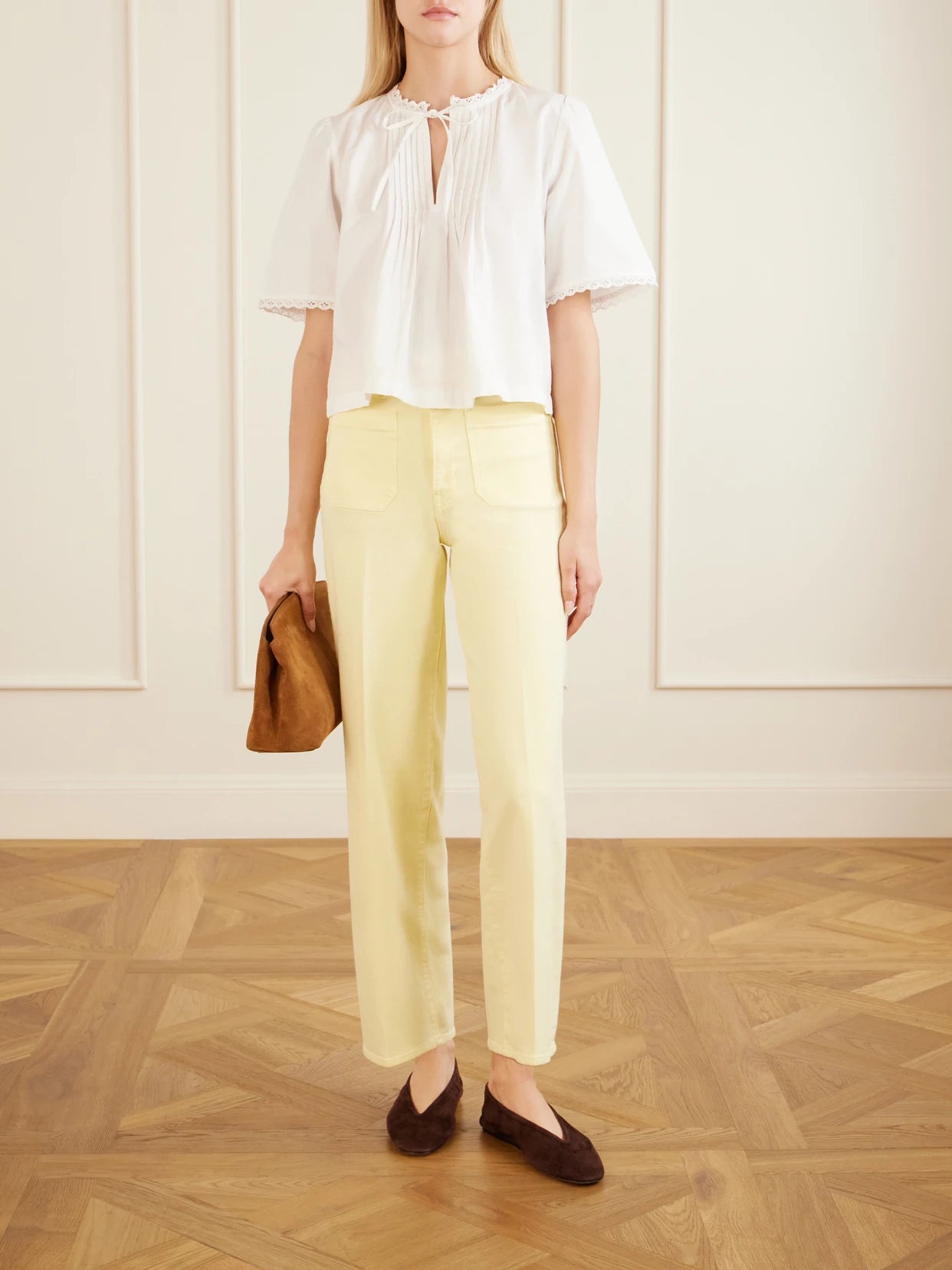Image of a model wearing Pants. Product name - High Rise Slim Wide Cotton-blend Wide-leg Pants in Yellow colour by brand - FRAME