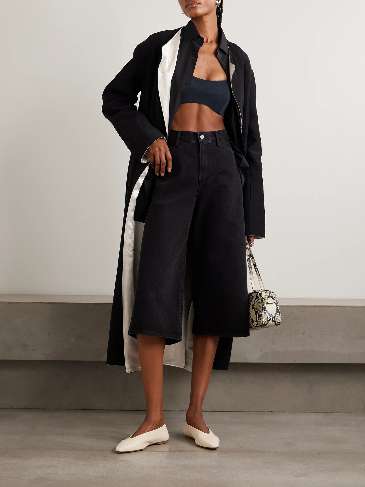 Image of a model wearing Tops. Product name - + Maria Mcmanus Organic And Recycled-denim Bandeau Top in Black colour by brand - AGOLDE