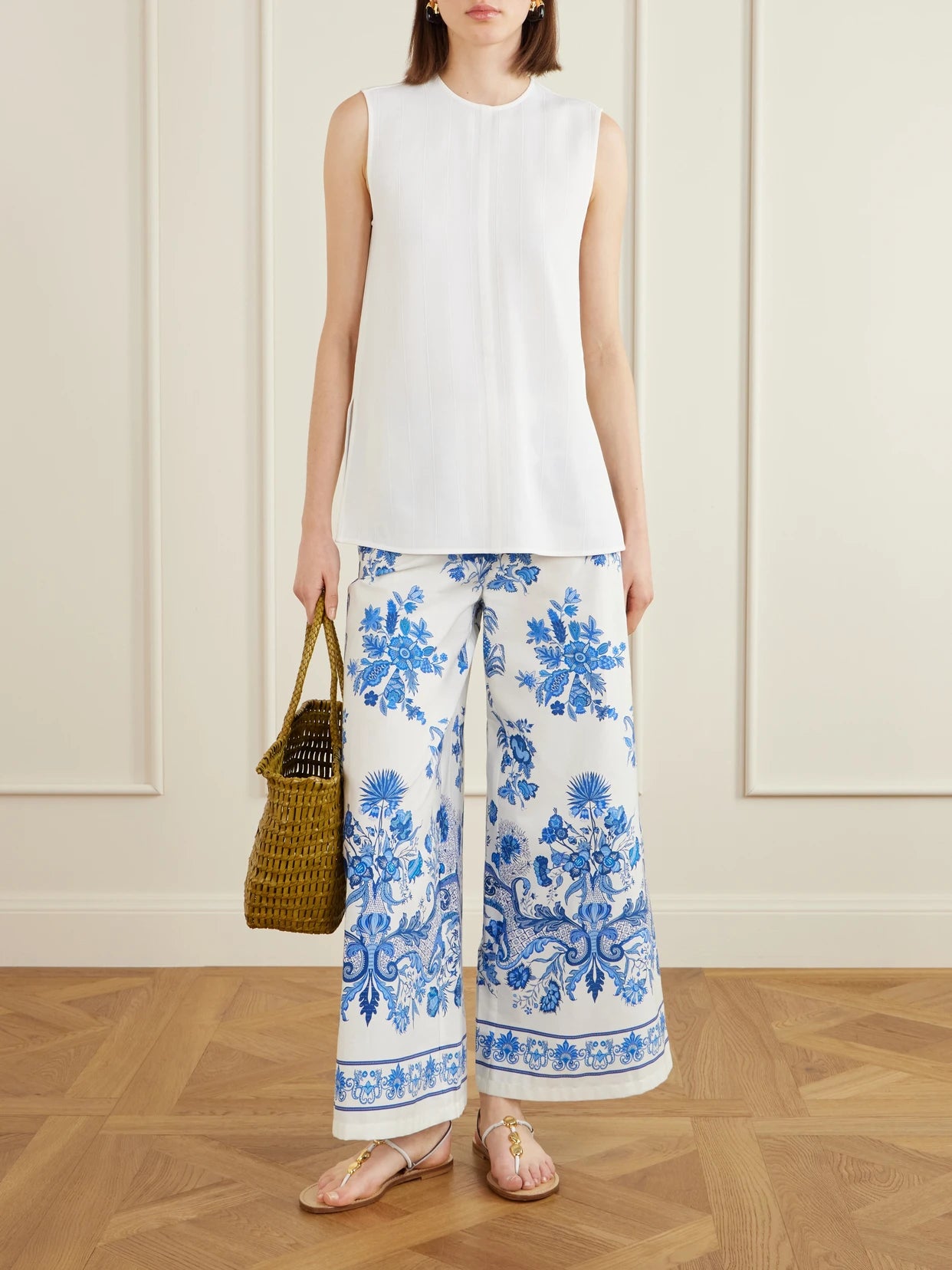 Image of a model wearing Pants. Product name - Floral Printed Cotton Wide-leg Pants in Blue colour by brand - Emporio Sirenuse