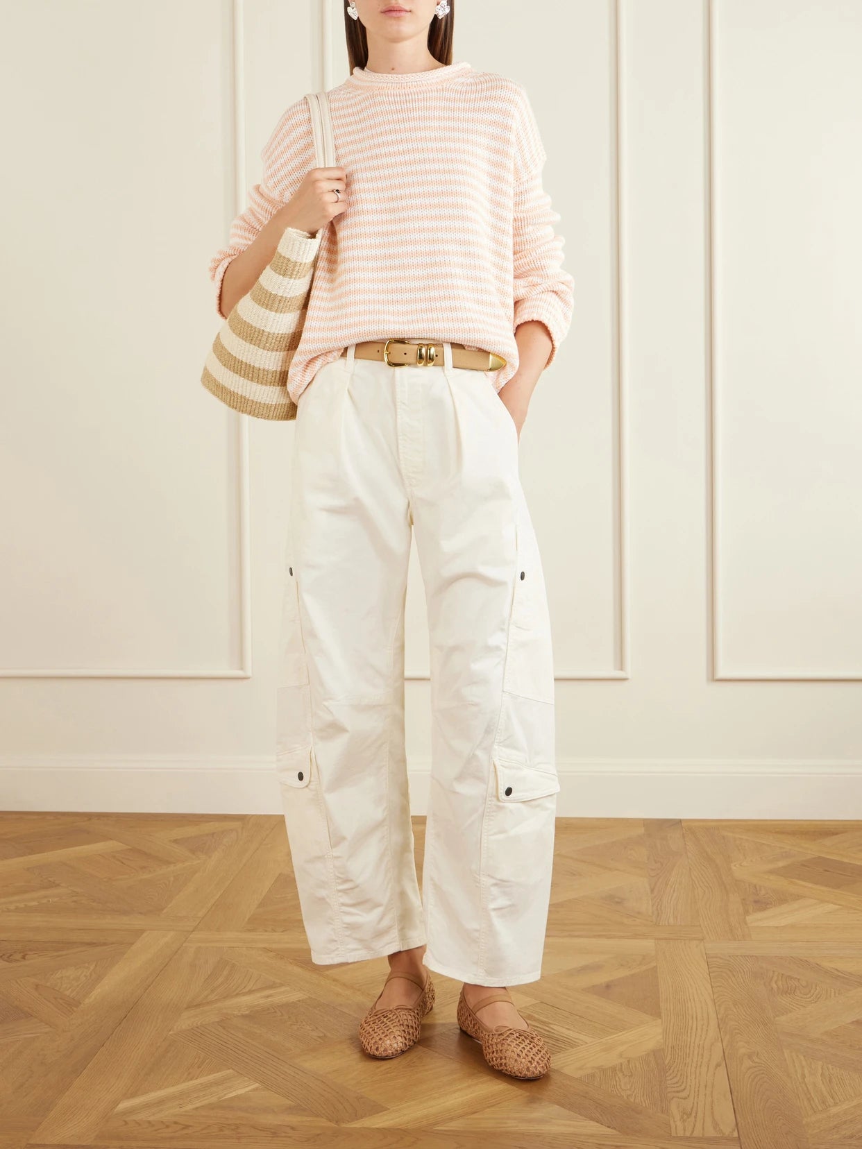 Image of a model wearing Outerwear. Product name - Striped Knitted Sweater in Peach colour by brand - La Ligne