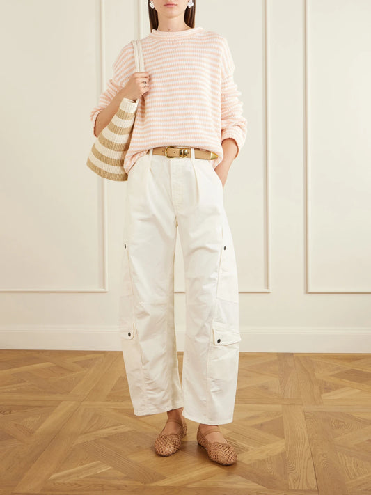 Image of a model wearing Outerwear. Product name - Striped Knitted Sweater in Peach colour by brand - La Ligne