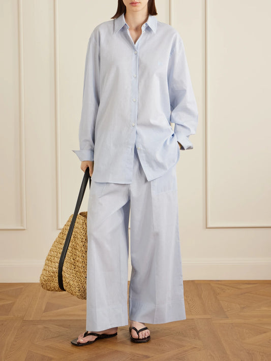 Image of a model wearing Pants. Product name - Cotton And Linen-blend Wide-leg Pants in Light blue colour by brand - TOTEME