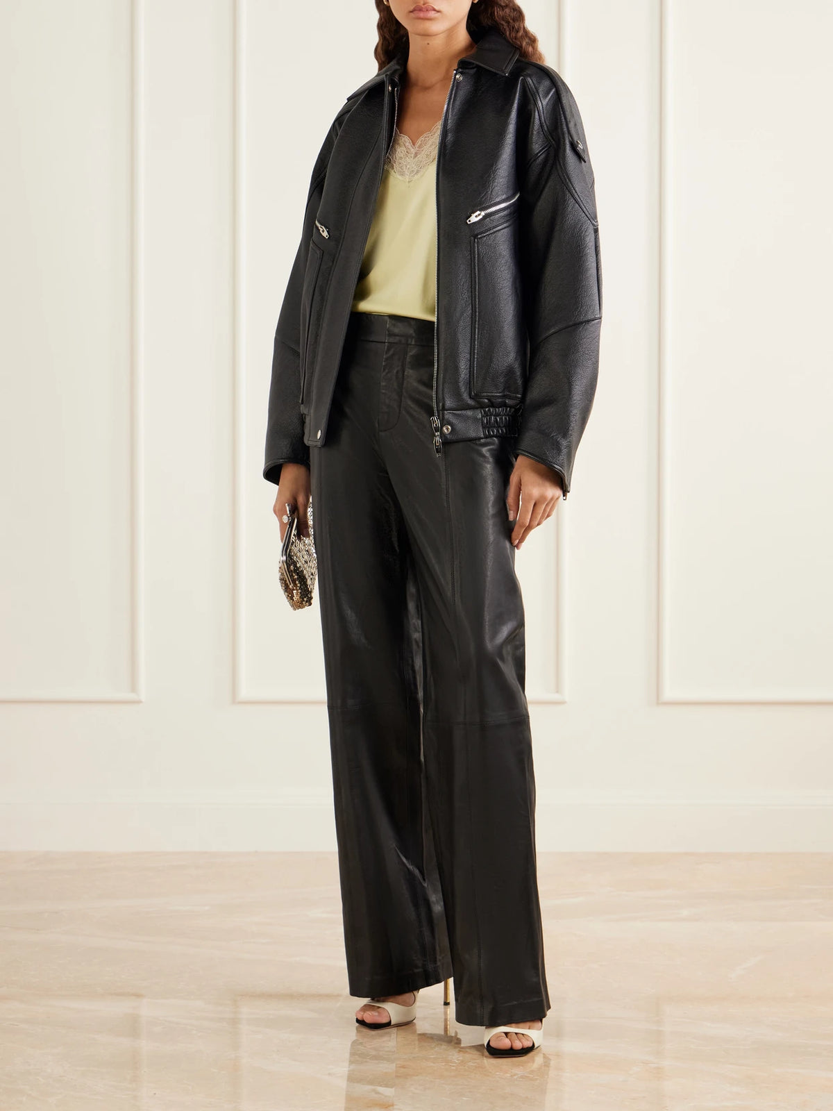 Image of a model wearing Pants. Product name - Paneled Leather Wide-leg Pants in Black colour by brand - RABANNE