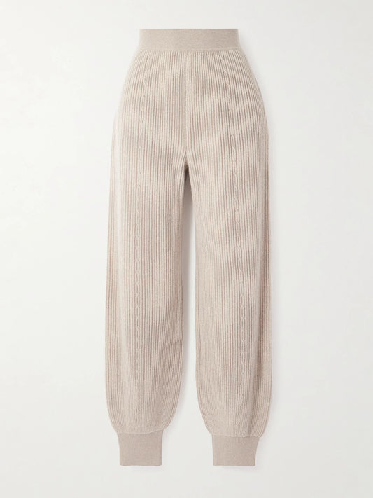 Image of a model wearing Pants. Product name - Plane Tree Ribbed Cashmere-blend Tapered Pants in Beige colour by brand - Loro Piana