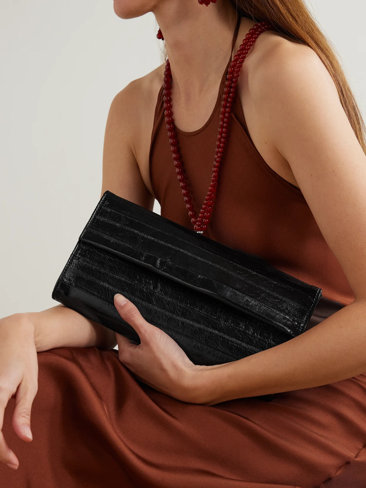 Image of Bags. Product name - Lydia Eel Clutch in Black colour by brand - Le Sundial