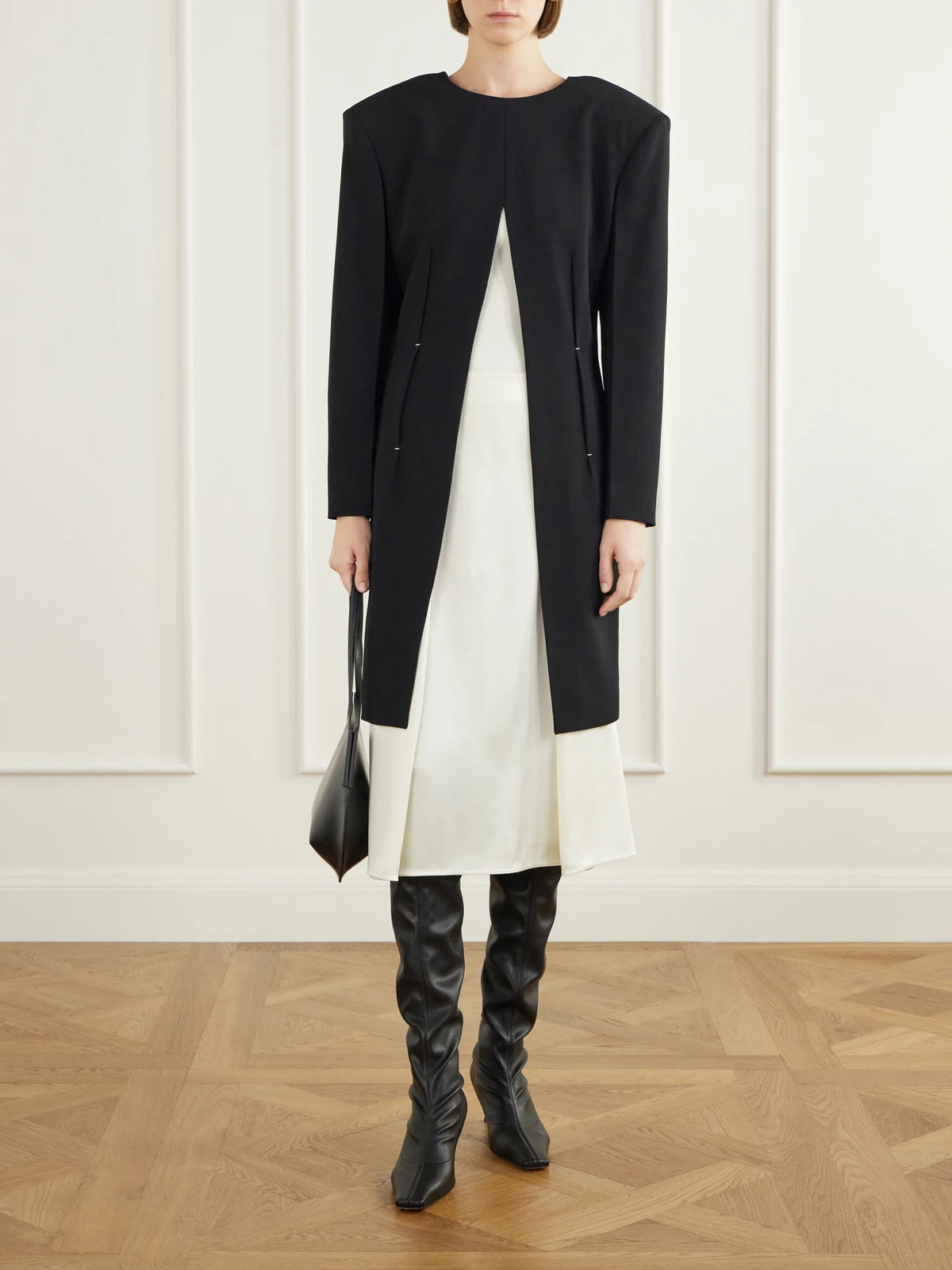 Image of a model wearing Tops. Product name - Pleated Wool Coat in Black colour by brand - Jil Sander