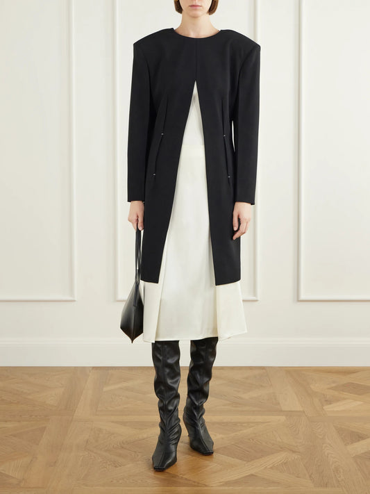 Image of a model wearing Tops. Product name - Pleated Wool Coat in Black colour by brand - Jil Sander