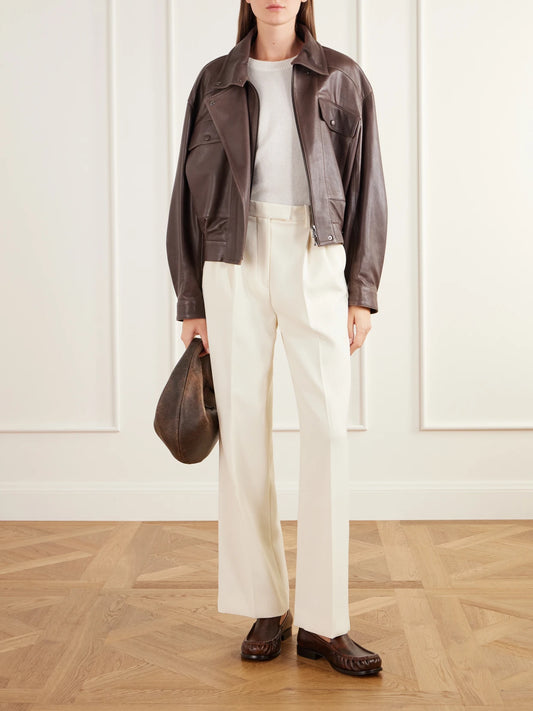 Image of a model wearing Pants. Product name - Pleated Twill Straight-leg Pants in Cream colour by brand - Almada