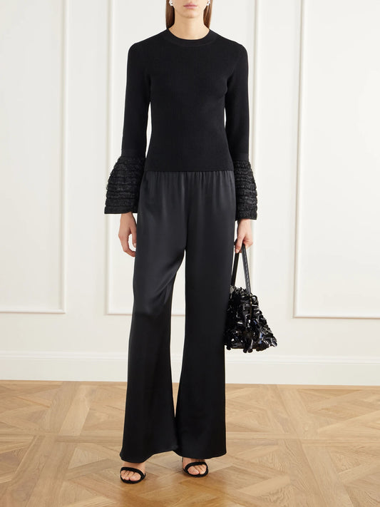Image of a model wearing Pants. Product name - Roni Satin Wide-leg Pants in Black colour by brand - SIMKHAI