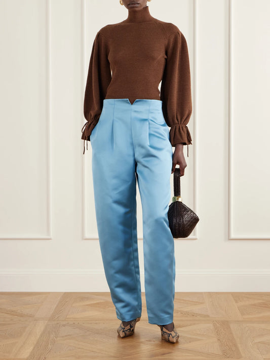 Image of a model wearing Pants. Product name - Edlyn Pleated Duchess-satin Mid-rise Barrel-leg Pants in Blue colour by brand - Ulla Johnson
