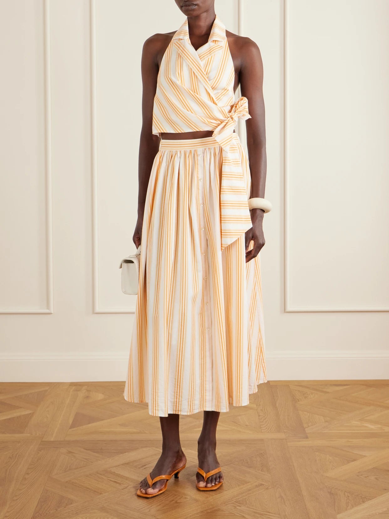 Image of Blouses. Product name - Wrapped Up Tie-detailed Striped Cotton Halterneck Blouse in Orange colour by brand - Rosie Assoulin