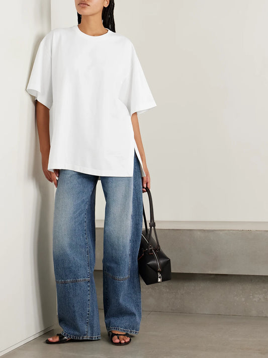 Image of a model wearing Tops. Product name - The Holt Oversized Organic Cotton-jersey T-shirt in White colour by brand - RÙADH
