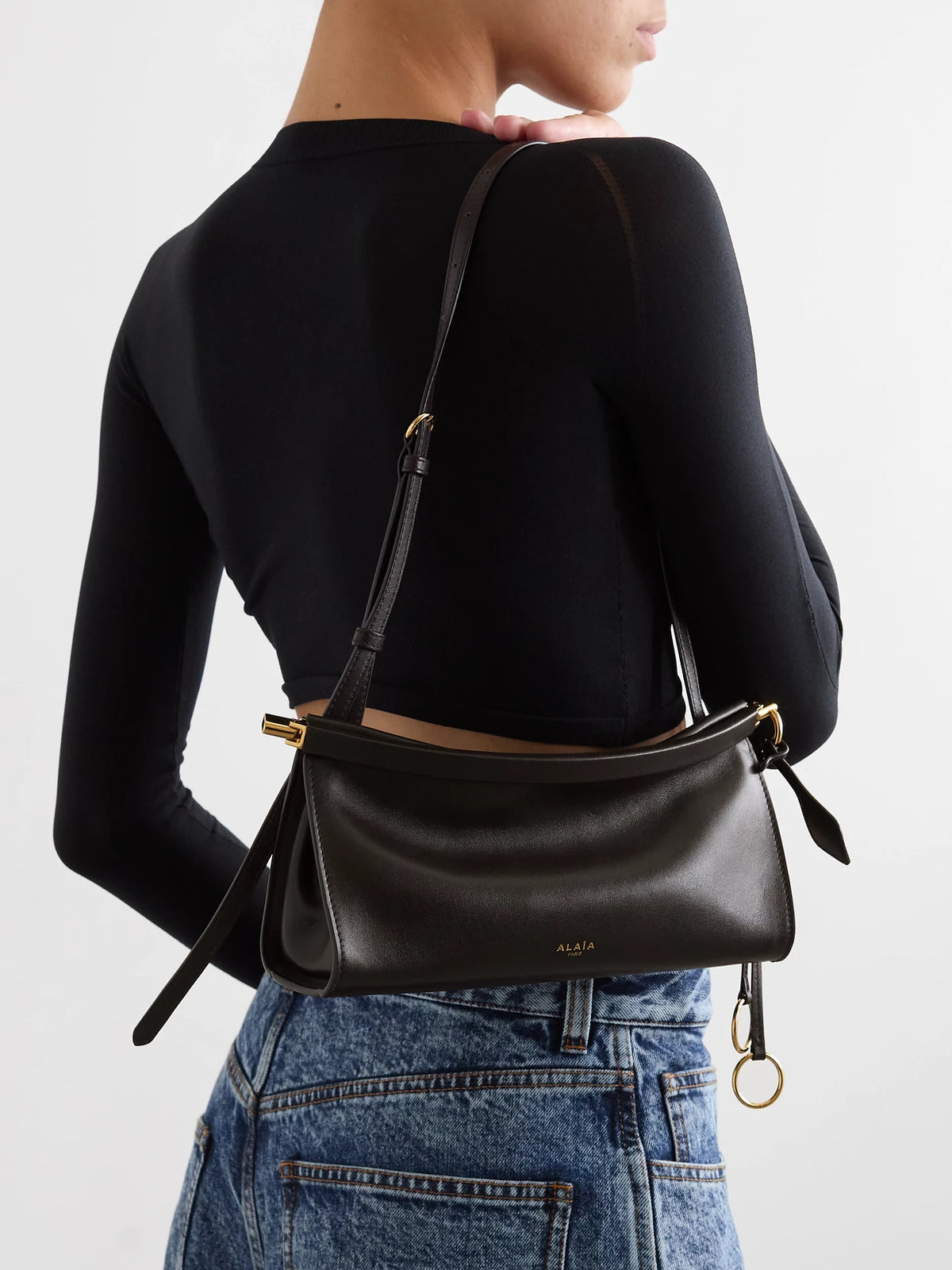 Image of Bags. Product name - Click E/w Small Leather Shoulder Bag in Dark brown colour by brand - Alaïa