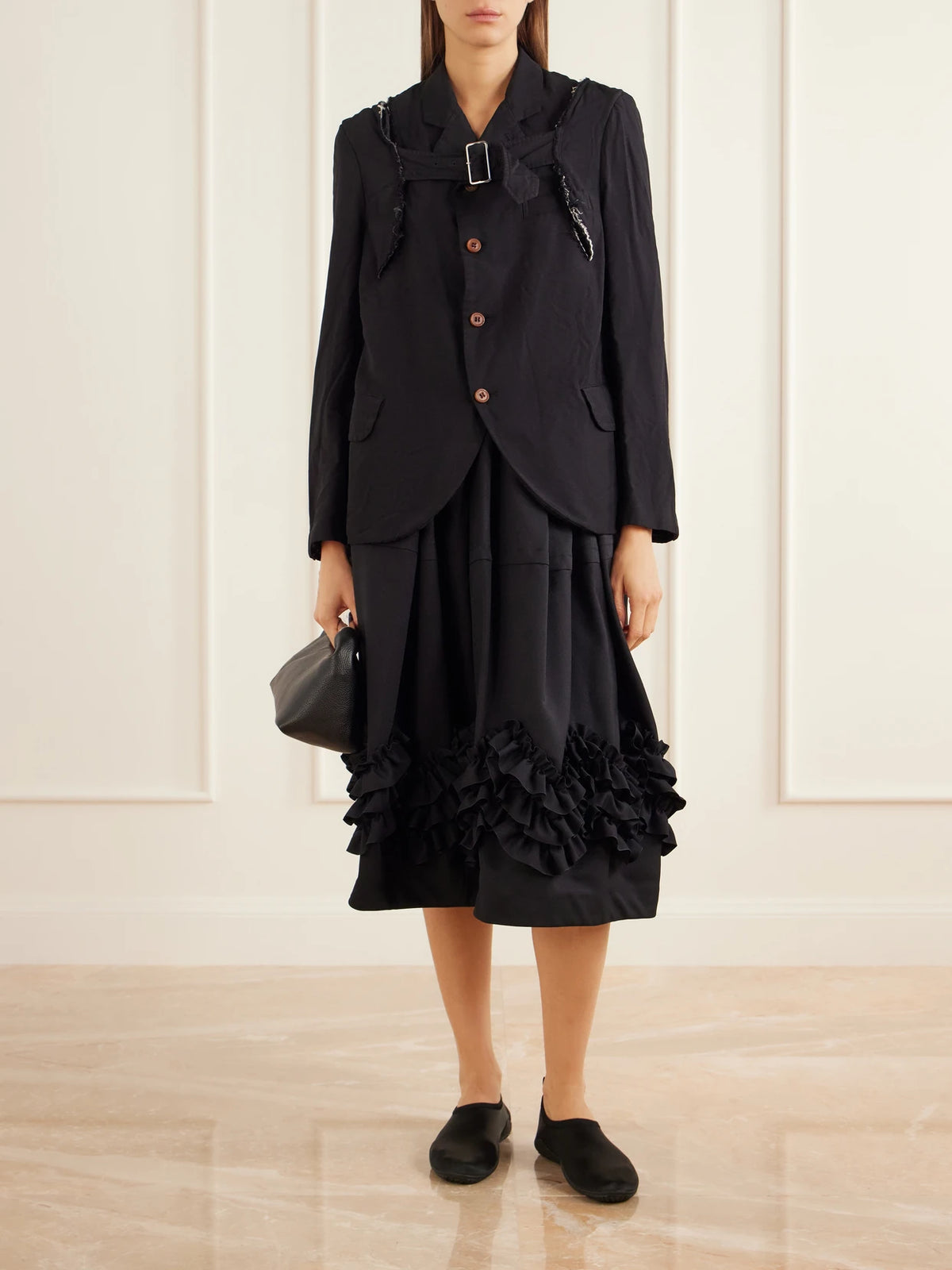 Image of a model wearing Skirts. Product name - Ruffle-detail Tiered Twill Midi Skirt in Black colour by brand - Comme des Garçons Comme des Garçons