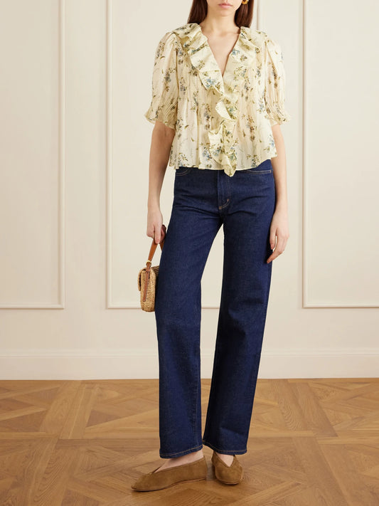 Image of a model wearing Tops. Product name - Henri Ruffled Pintucked Organic Cotton-voile Top in Pastel yellow colour by brand - DÔEN