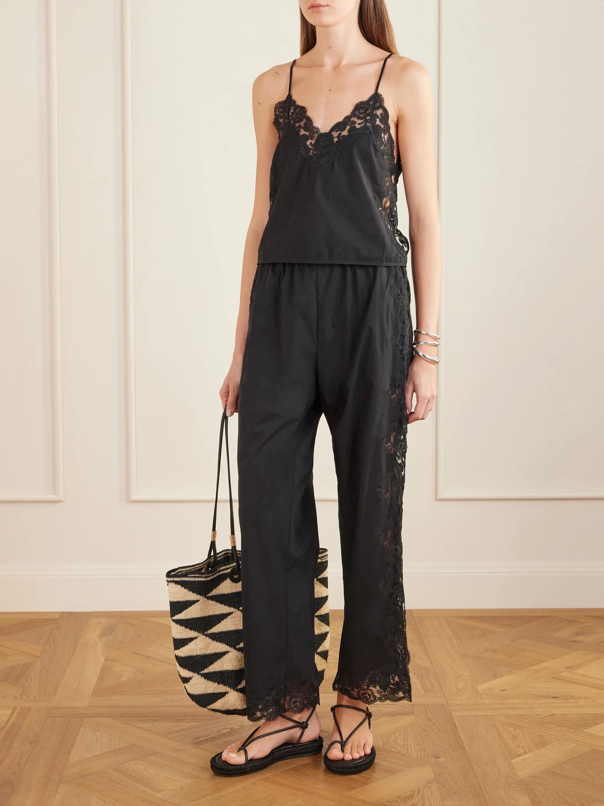 Image of a model wearing Tops. Product name - Oriana Lace-trimmed Cotton Tank in Black colour by brand - Loretta Caponi