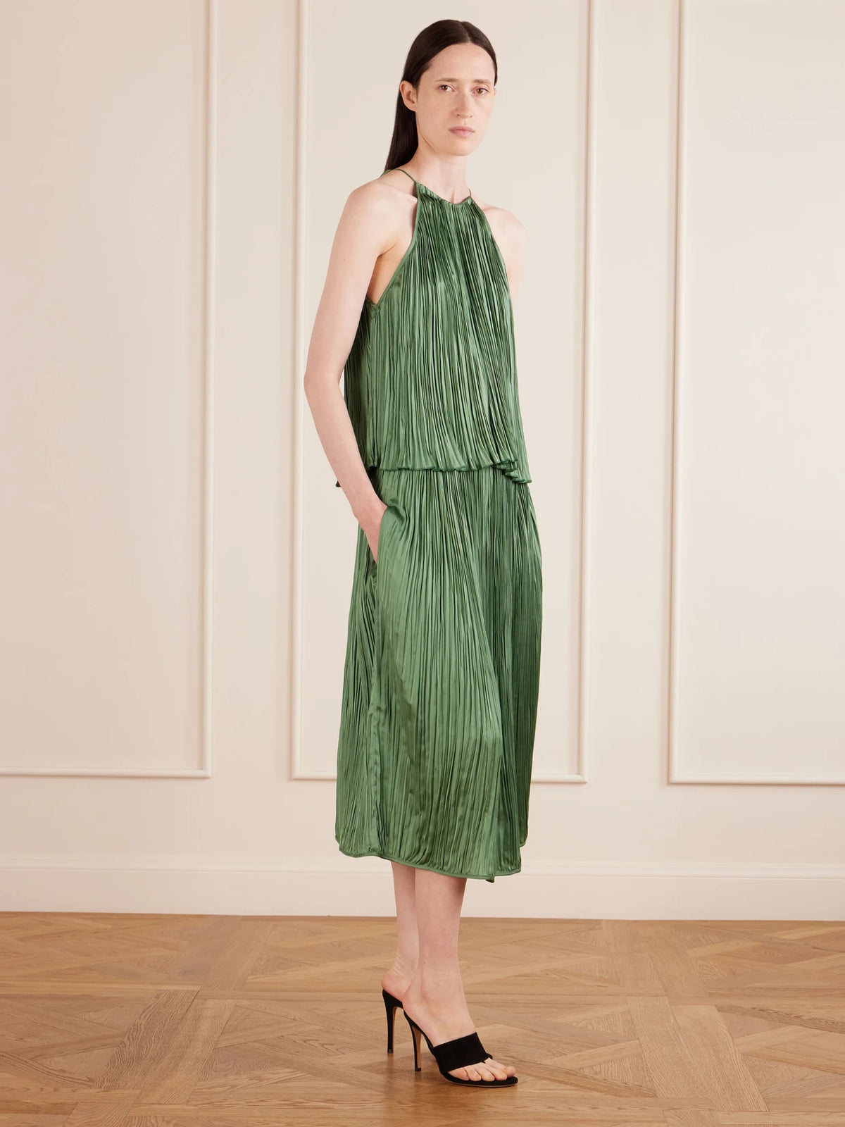 Image of a model wearing Skirts. Product name - Avelline Plissé-satin Midi Skirt in Green colour by brand - AFLALO
