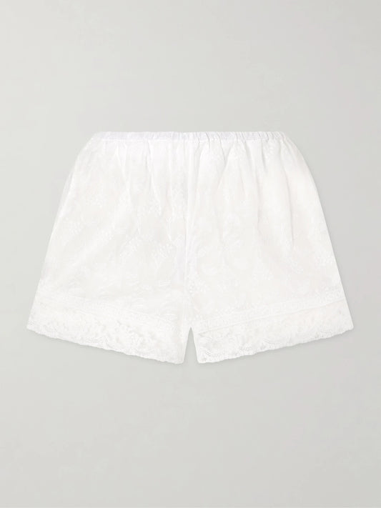 Image of a model wearing Shorts. Product name - Floralie Embroidered Cotton-blend Shorts in White colour by brand - Eres