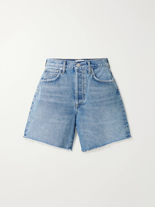 Image of a model wearing Shorts. Product name - Marlow Frayed Denim Shorts in Mid denim colour by brand - Citizens of Humanity