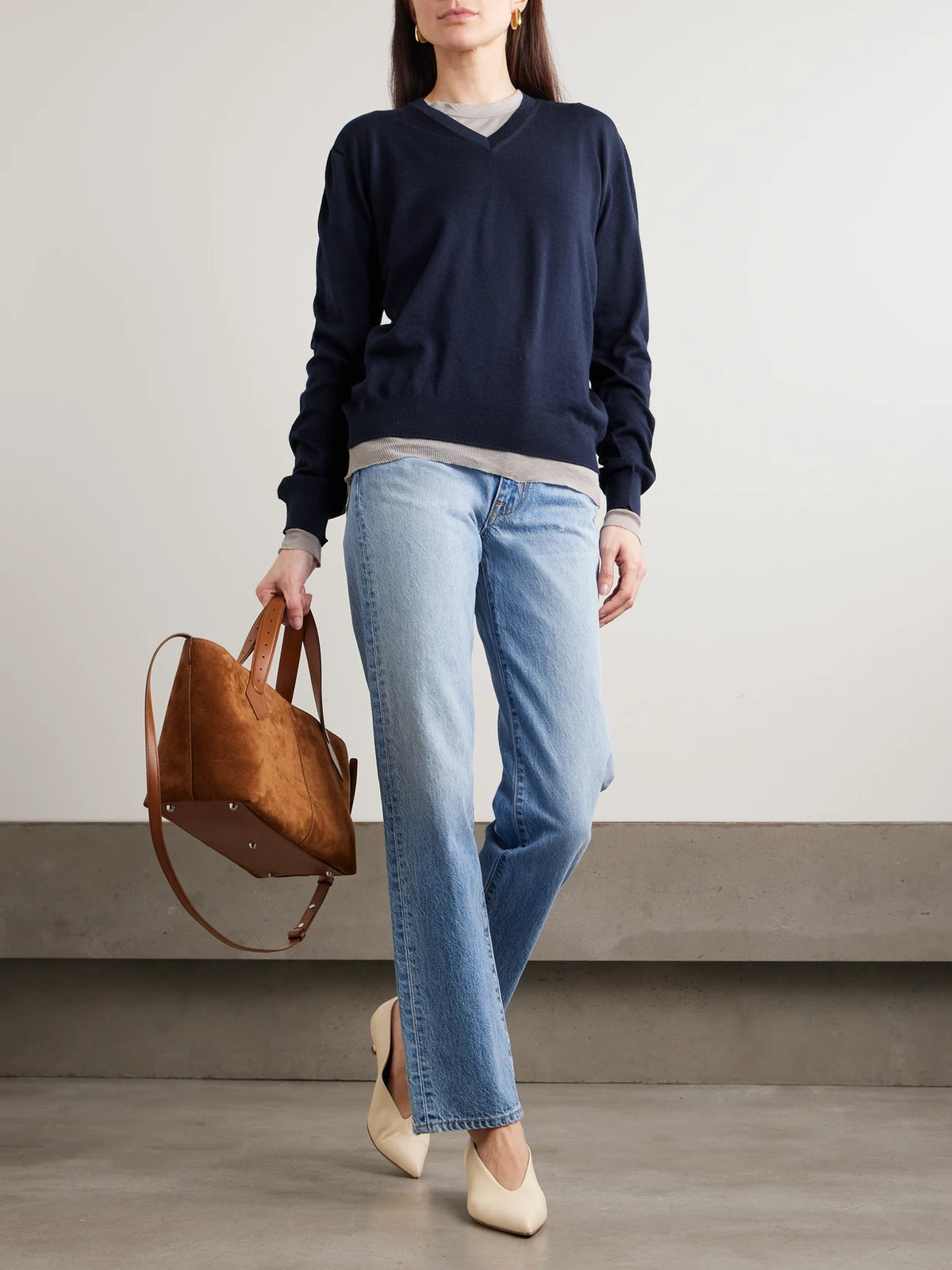 Image of a model wearing Outerwear. Product name - Oscar Embroidered Merino Wool Sweater in Navy colour by brand - RÙADH