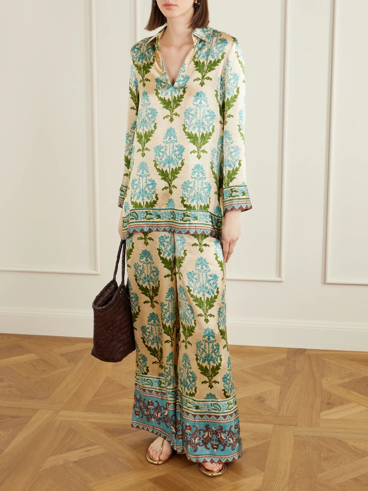Image of a model wearing Pants. Product name - Stephan Floral-print Silk-satin Trousers in Green colour by brand - Emporio Sirenuse