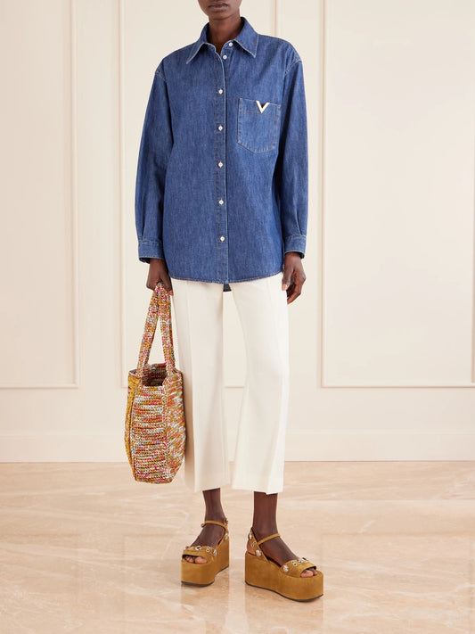 Image of a model wearing Tops. Product name - Embellished Cotton-denim Shirt in Dark denim colour by brand - Valentino Garavani
