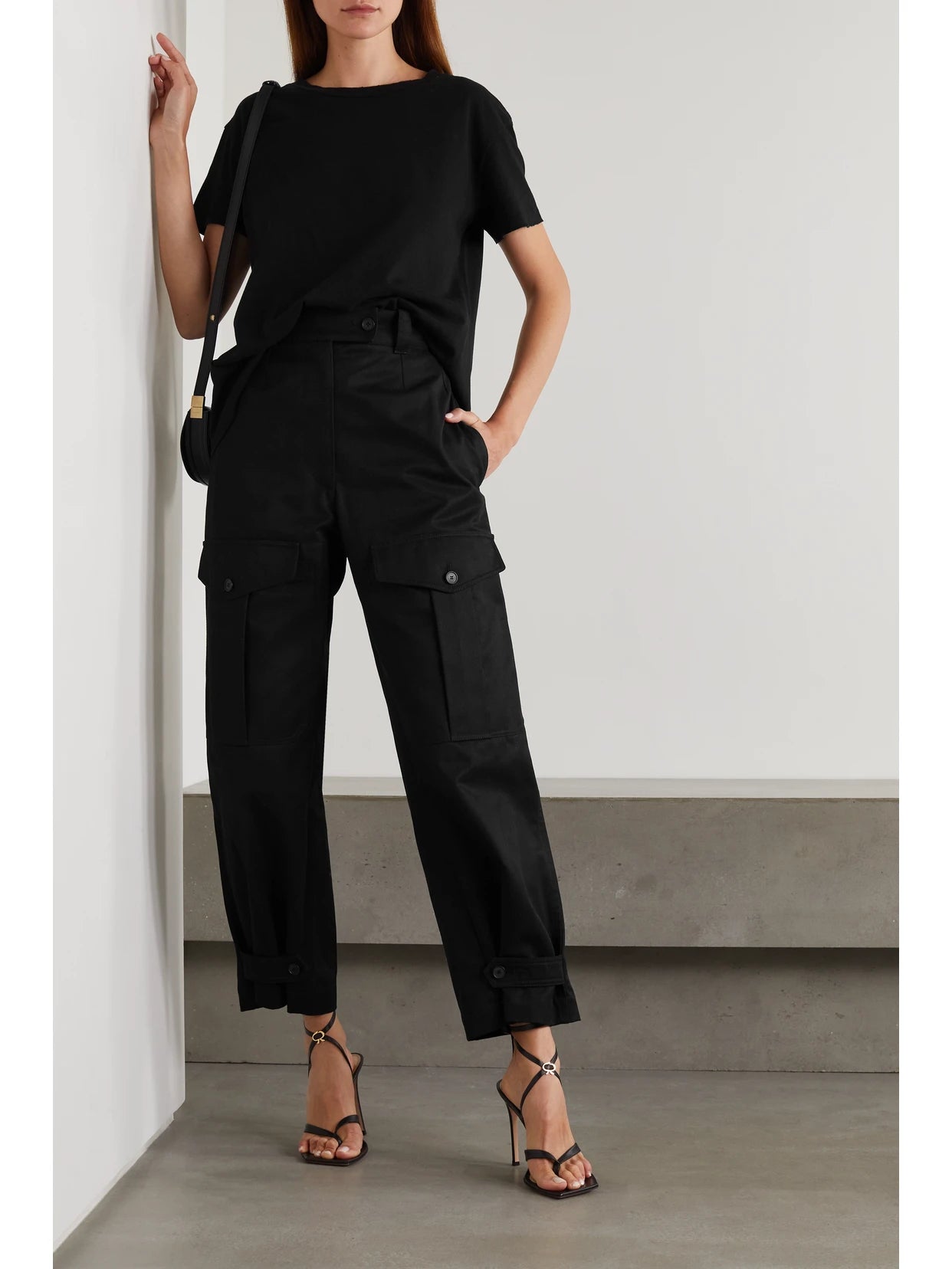 Image of a model wearing Tops. Product name - Brady Distressed Cotton-jersey T-shirt in Black colour by brand - Nili Lotan