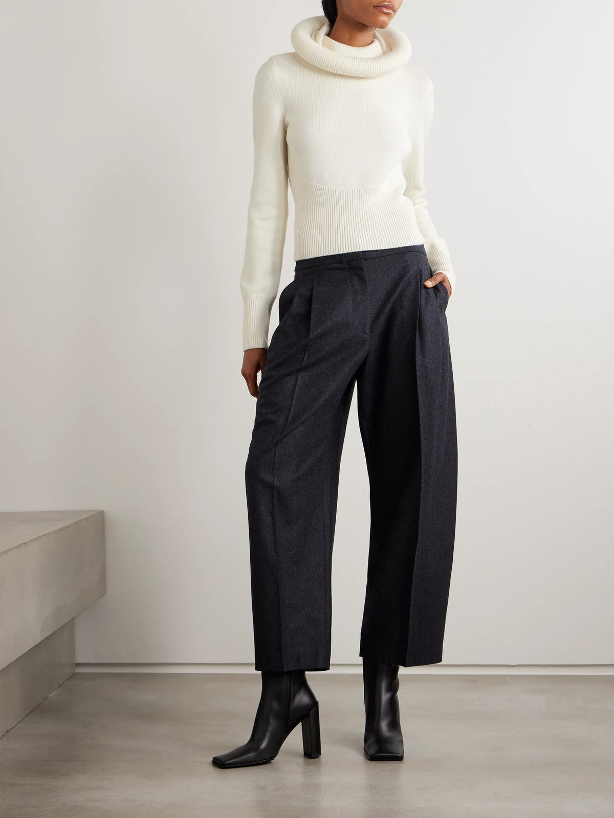 Image of a model wearing Outerwear. Product name - Wool Hooded Sweater in White colour by brand - Alaïa