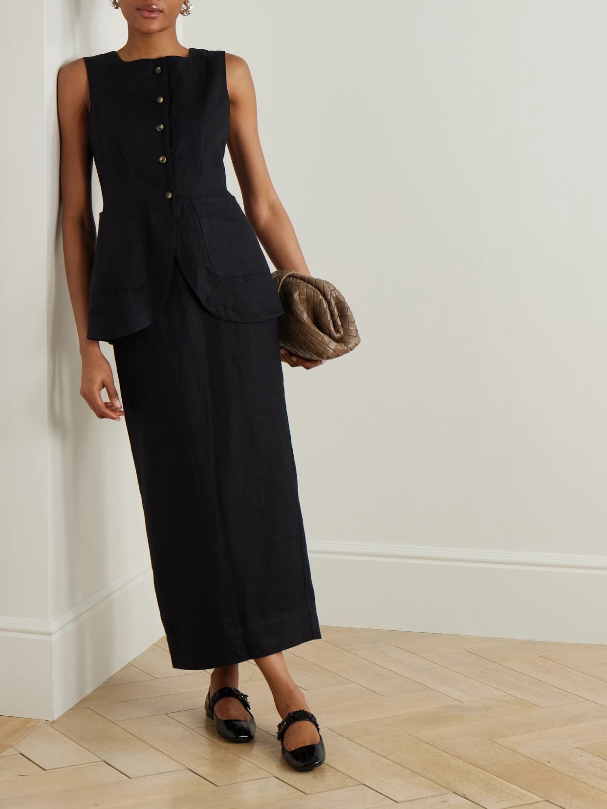 Image of a model wearing Skirts. Product name - Emma Linen Midi Skirt in Black colour by brand - Posse