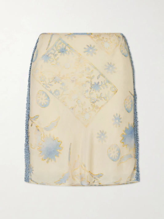 Image of a model wearing Skirts. Product name - Cecile Ruffled Printed Chiffon Midi Skirt in Cream colour by brand - SIR.