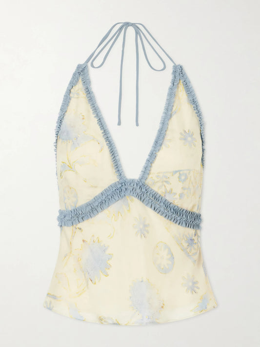 Image of a model wearing Tops. Product name - Cecile Ruffled Printed Chiffon Halter Top in Cream colour by brand - SIR.