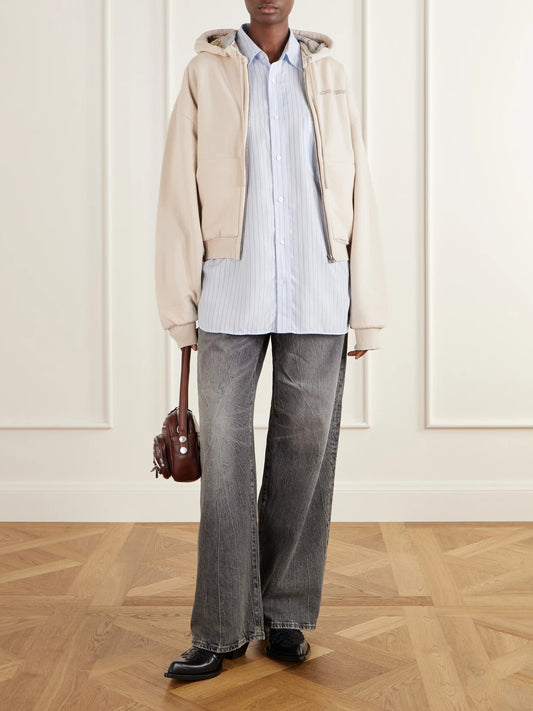 Image of a model wearing Tops. Product name - Embroidered Cotton Zip-up Hoodie in Beige colour by brand - Acne Studios