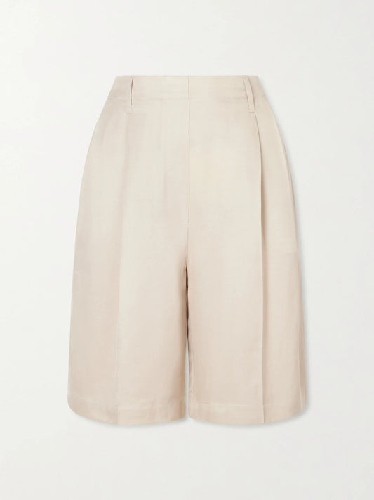 Image of a model wearing Shorts. Product name - Kim Pleated Woven Shorts in Beige colour by brand - LESET