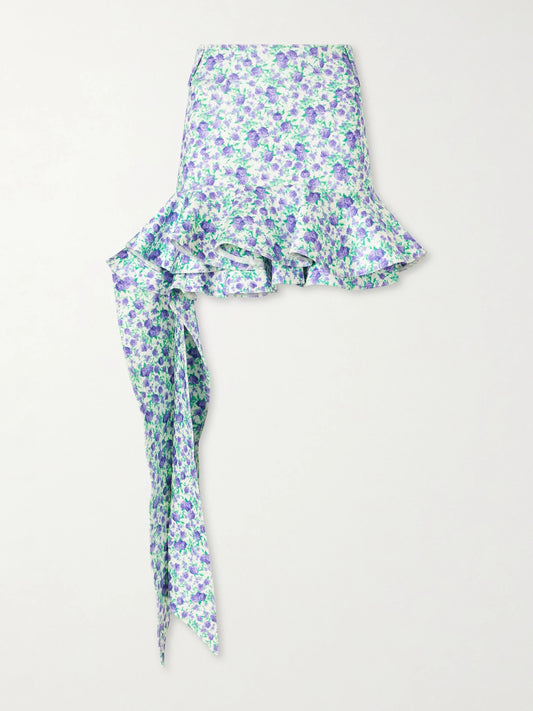 Image of a model wearing Skirts. Product name - Tie-detailed Ruffled Floral-print Stretch-jersey Mini Skirt in Blue colour by brand - RABANNE