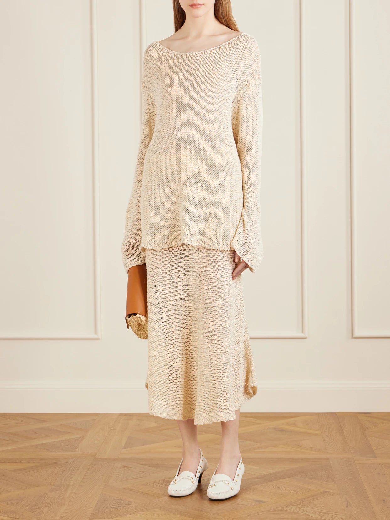 Image of a model wearing Skirts. Product name - Inaya Crocheted Cotton And Silk-blend Midi Skirt in Ivory colour by brand - KHAITE