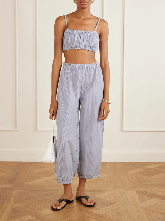 Image of a model wearing Tops. Product name - Bea Shirred Striped Cotton-poplin Bandeau Top in Navy colour by brand - Suzie Kondi