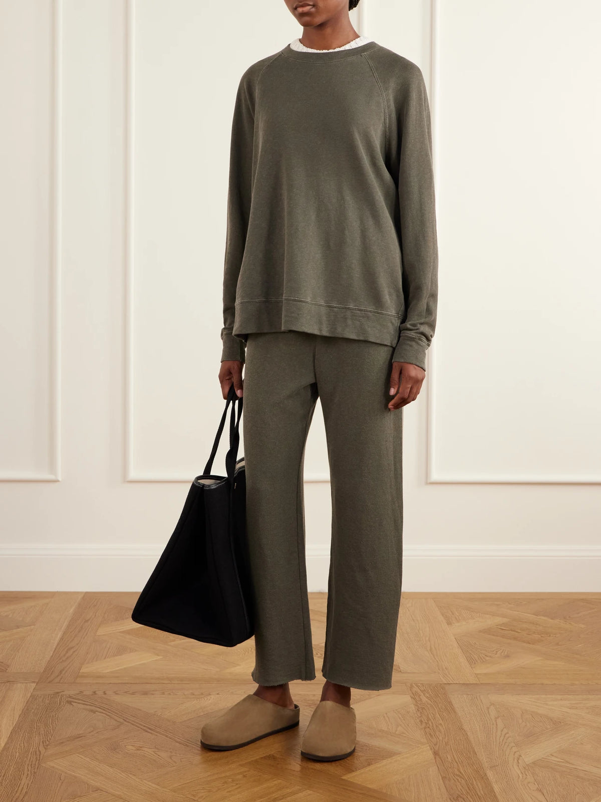 Image of a model wearing Pants. Product name - Cropped Brushed Cotton-terry Track Pants in Army green colour by brand - James Perse