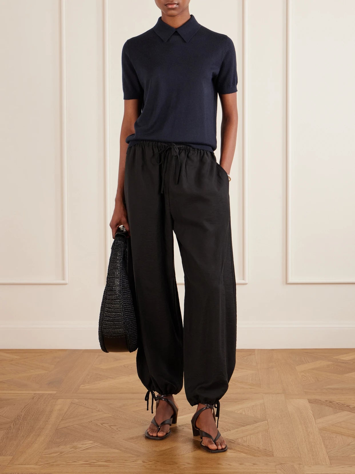 Image of a model wearing Outerwear. Product name - Naara Cashmere Polo T-shirt in Navy colour by brand - LISA YANG