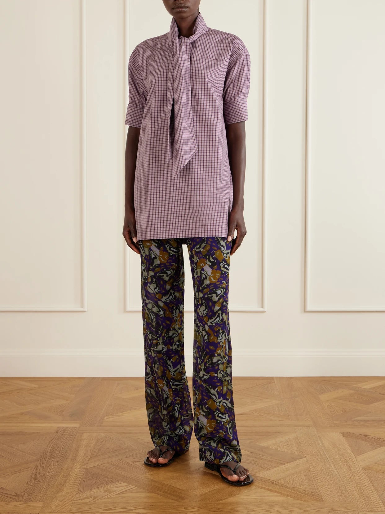 Image of a model wearing Tops. Product name - Tie-detailed Checked Cotton-poplin Blouse in Purple colour by brand - Dries Van Noten