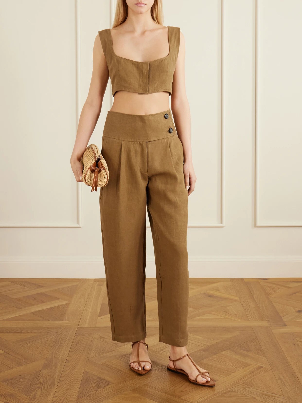Image of a model wearing Pants. Product name - Dafash High-rise Pleated Linen Straight-leg Pants in Brown colour by brand - Le Kasha