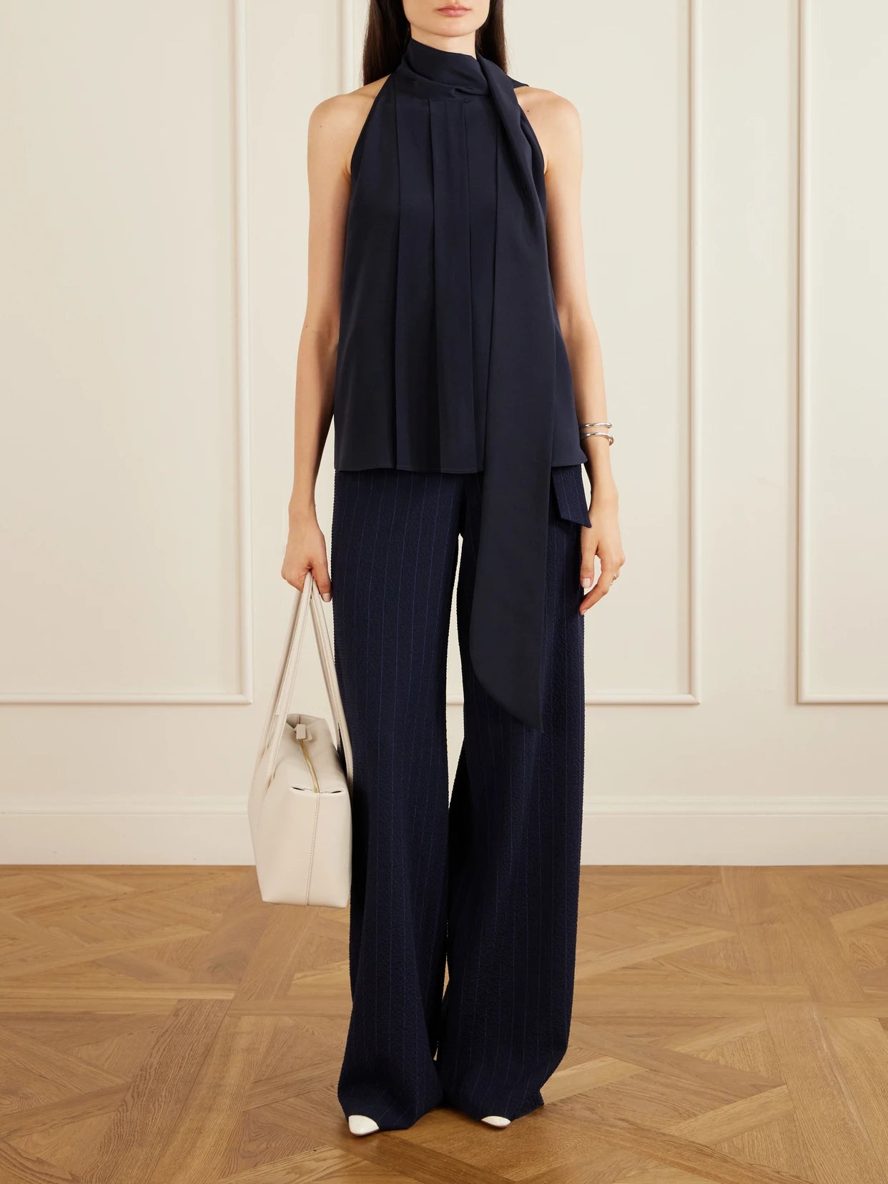 Image of a model wearing Pants. Product name - Striped Seersucker Virgin Wool-blend Pants in Navy colour by brand - Max Mara