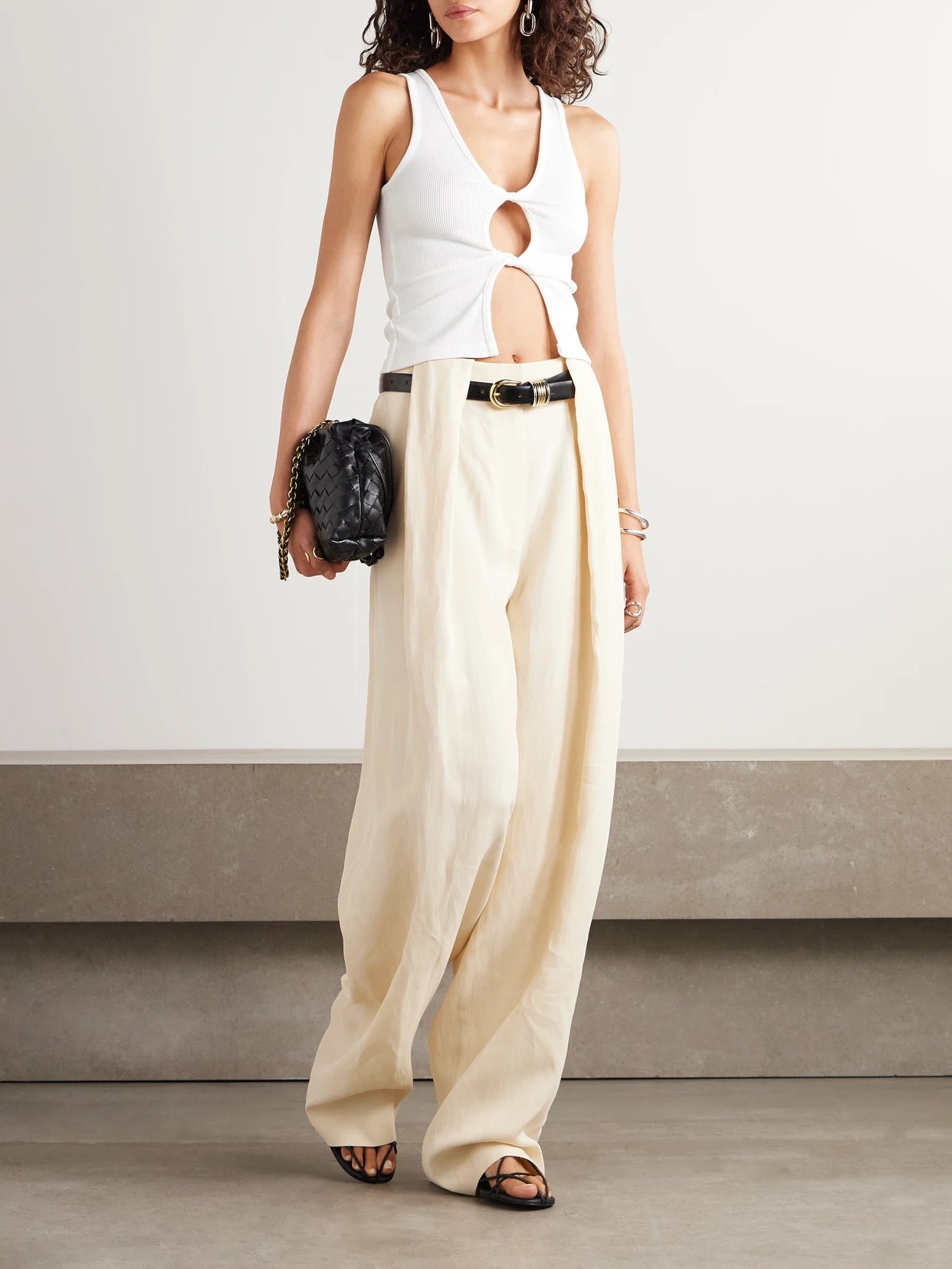 Image of a model wearing Tops. Product name - Cutout Twist-front Ribbed-knit Tank in White colour by brand - Christopher Esber