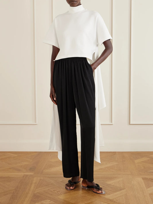 Image of a model wearing Tops. Product name - Asymmetric Cotton-blend Jersey T-shirt in White colour by brand - Alaïa