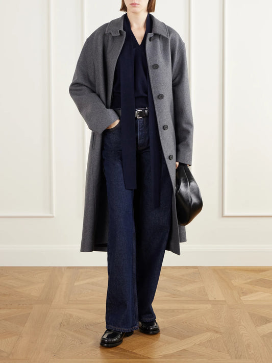 Image of a model wearing Outerwear. Product name - Ellisyn Tie-detailed Knitted Cashmere Sweater Vest in Navy colour by brand - LISA YANG